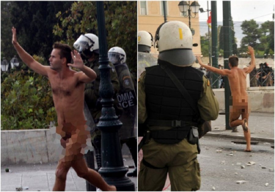 Η πιο επεισοδιακή επίσκεψη της Μέρκελ στην Ελλάδα είχε... ναζιστικές σημαίες, μούτζες και έναν γυμνό διαδηλωτή (εικόνες)